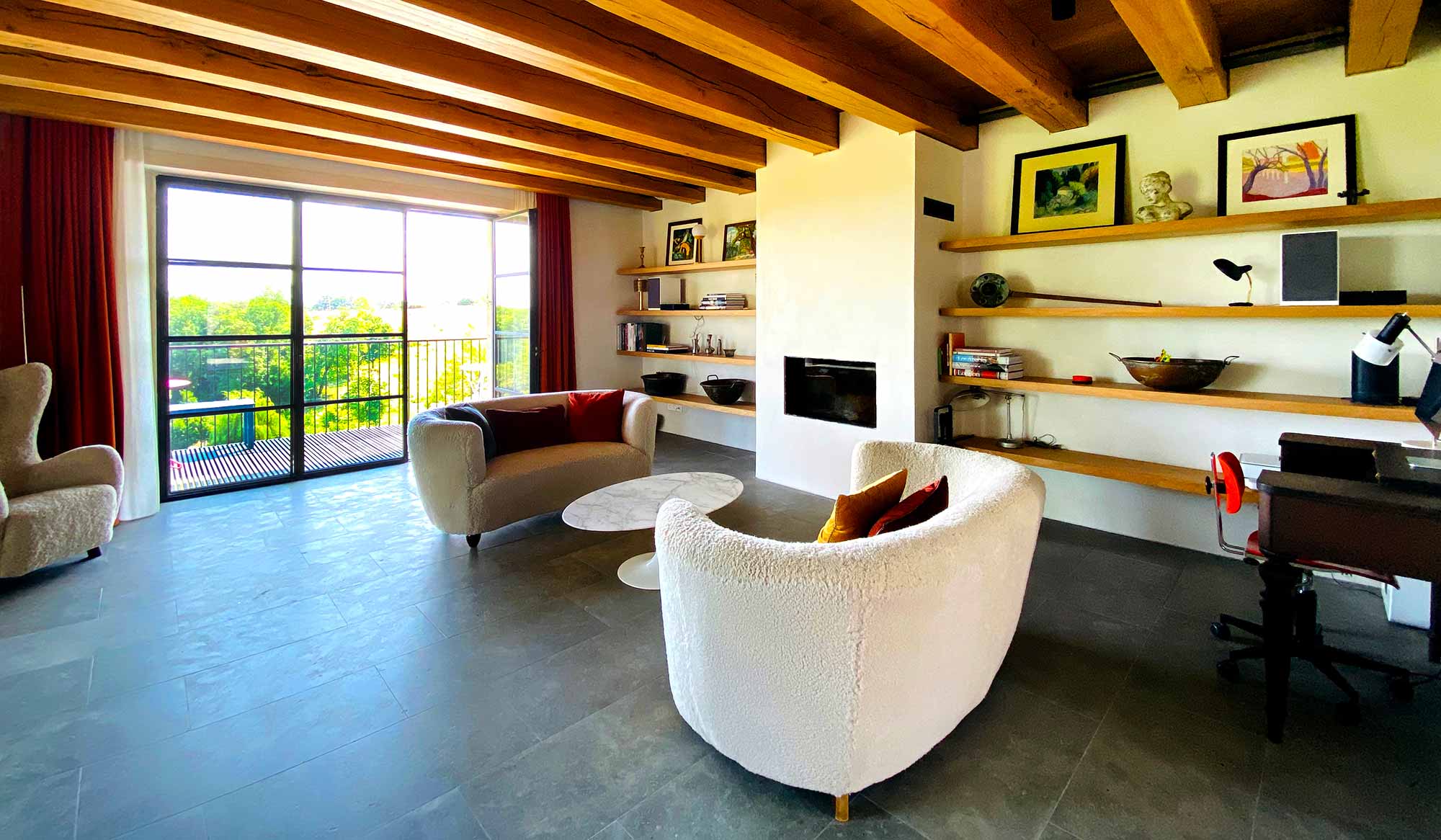 Welcoming In Outdoors: the original dark living room of the Main House was enhanced with enlarged openings and higher ceilings.