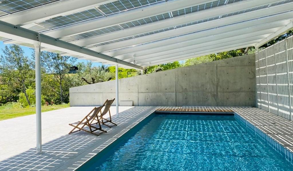 A Sustainable Beacon: With 70 Bifacial PV panels, the new roof of the pool house celebrates the power of sustainability, and marks the landscape as a possible future for the region.